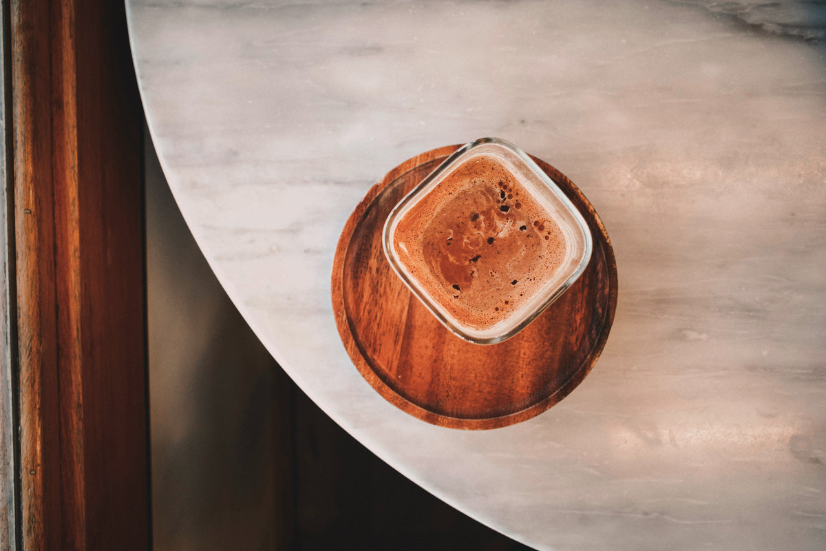Pour hot water into the pod → one espresso. Add equal parts warm milk.
