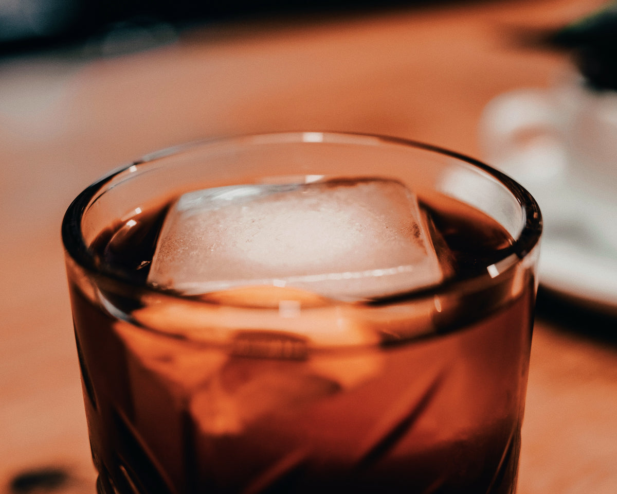 Pour hot water into the pod and pour over ice → one cold shot. Add a splash of cold water.