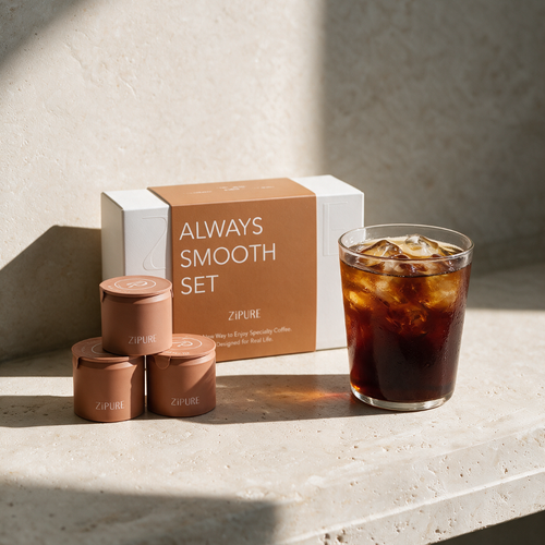 ZIPURE Always Smooth Black Ethiopia box with three coffee pod tins and a glass of iced coffee