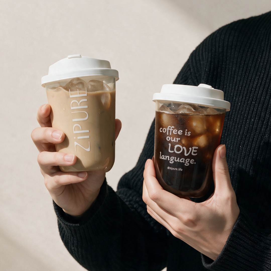 Two ZIPURE Grab & Sip 16oz cups held side by side - iced latte and black espresso